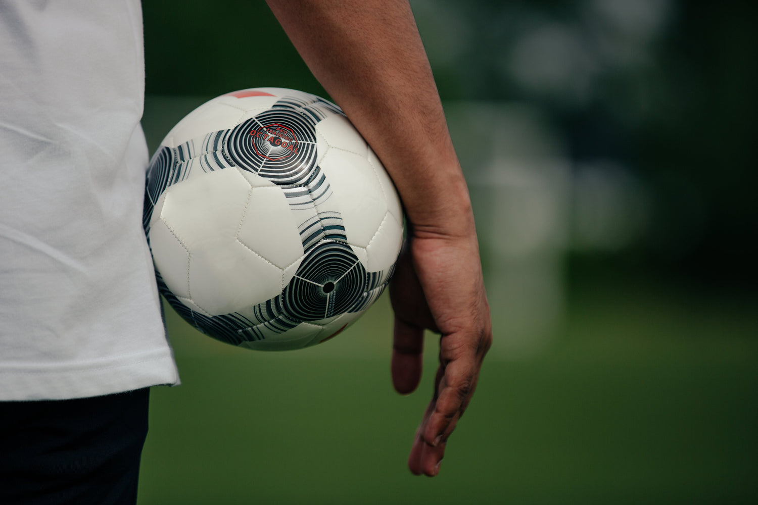 FC Way Soccer coach holding a ball for World Cup Summer Camp in Port Charlotte.