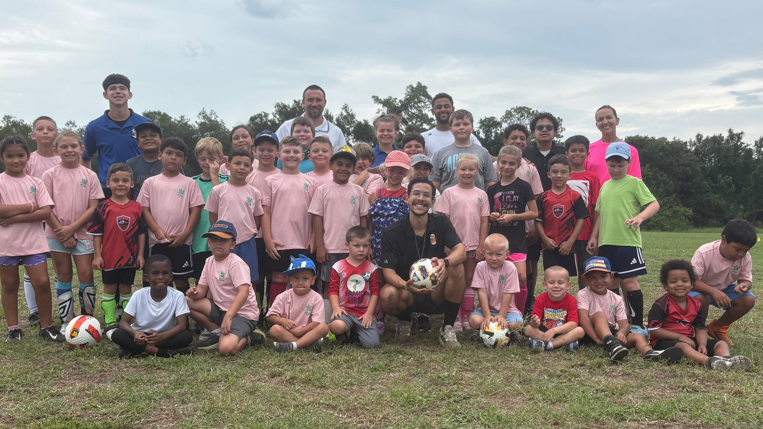 Group photo of children and coaches at FC Way Soccer Camp in Port Charlotte, Florida